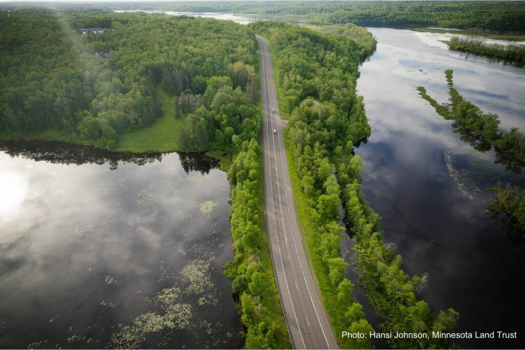 An aerial photo showing a road between two waterbodies